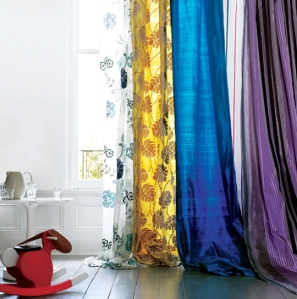 I love the thought of using many bright colored curtains all on one rod and letting them pool down onto the floor